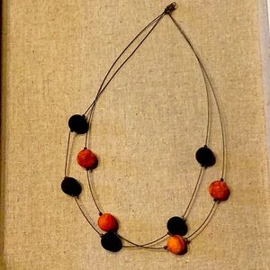 Black and terra cotta lava bead necklace. Falls at collarbone. Simple clasp.